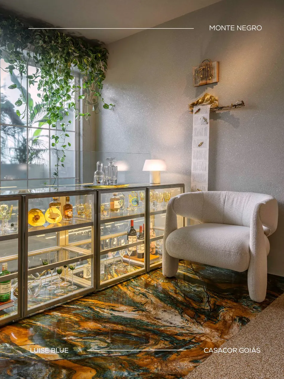 Vitrine de vidro e poltrona clara sobre piso contínuo em Luise Blue ®